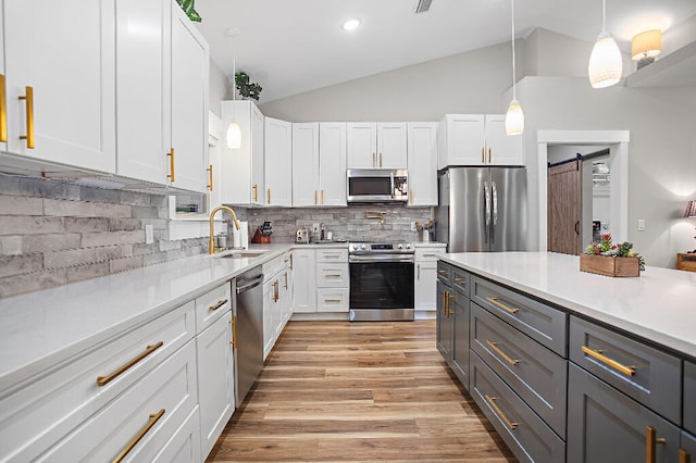 3112 Evans Ave, Navarre, FL 32566 - kitchen featuring stainless steel appliances, white cabinets, light countertops, vaulted ceiling, and backsplash