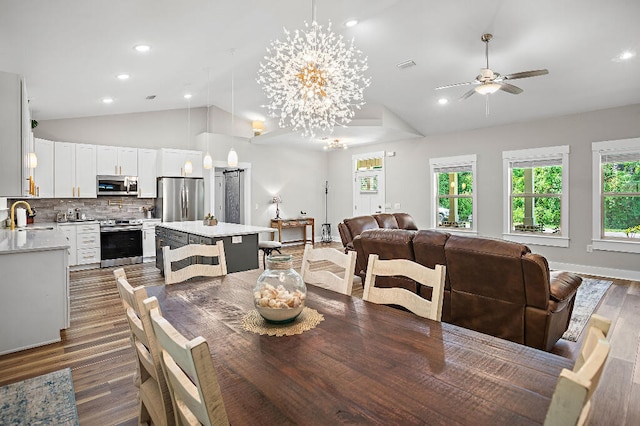 3112 Evans Ave, Navarre, FL 32566 - dining area featuring vaulted ceiling, a ceiling fan, dark wood finished floors, recessed lighting, and a chandelier