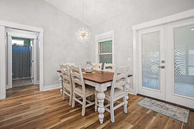 3112 Evans Ave, Navarre, FL 32566 - dining room with dark wood-type flooring, vaulted ceiling, healthy amount of natural light, a chandelier, and french doors