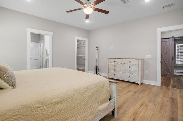 3112 Evans Ave, Navarre, FL 32566 - bedroom featuring hardwood / wood-style floors, a spacious closet, recessed lighting, ensuite bath, and a closet