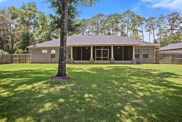 3112 Evans Ave, Navarre, FL 32566 - back of house featuring a sunroom, a fenced backyard, brick siding, and roof with shingles