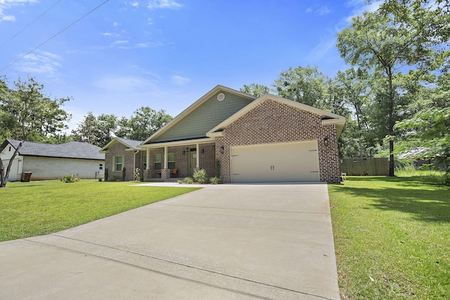 3112 Evans Ave, Navarre, FL 32566 - view of front facade featuring an attached garage, concrete driveway, brick siding, and covered porch