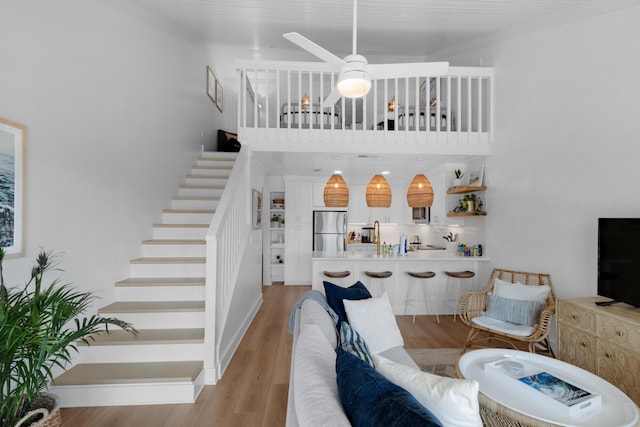 4984 W County Highway 30a Unit 5B, Santa Rosa Beach, FL 32459 - living area featuring stairway, light wood-style floors, and a ceiling fan