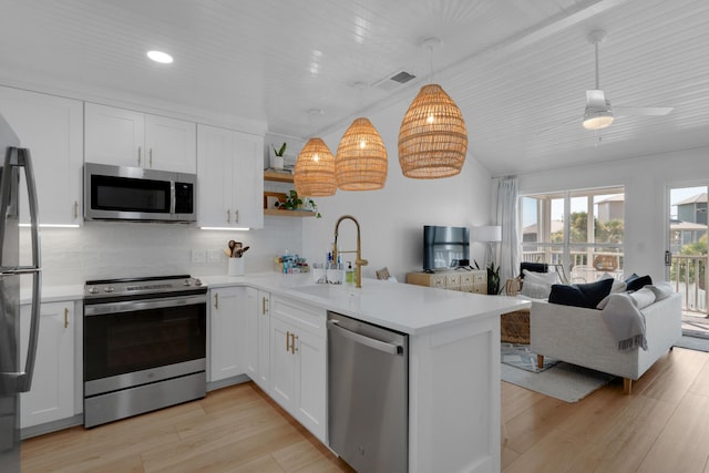 4984 W County Highway 30a Unit 5B, Santa Rosa Beach, FL 32459 - kitchen with stainless steel appliances, open shelves, a peninsula, backsplash, and white cabinets
