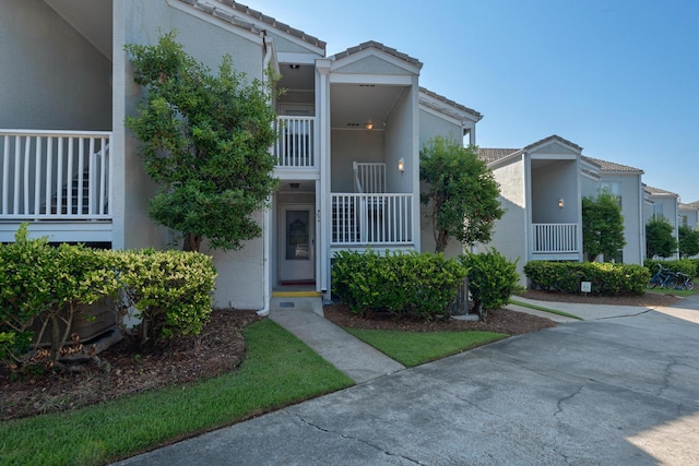 4984 W County Highway 30a Unit 5B, Santa Rosa Beach, FL 32459 - view of front of house with stucco siding and a tiled roof