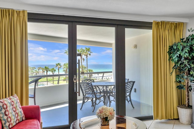291 Scenic Gulf Dr Unit 400, Miramar Beach, FL 32550 - dining room featuring a water view, healthy amount of natural light, french doors, and light tile patterned floors