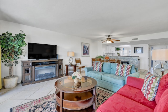 291 Scenic Gulf Dr Unit 400, Miramar Beach, FL 32550 - living area featuring a ceiling fan, light tile patterned flooring, and a glass covered fireplace