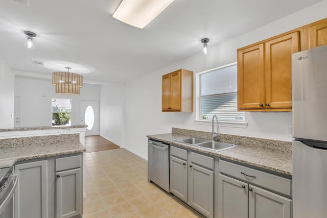 1014 Airport Rd Unit 163, Destin, FL 32541 - kitchen featuring stainless steel appliances, healthy amount of natural light, gray cabinets, and light countertops