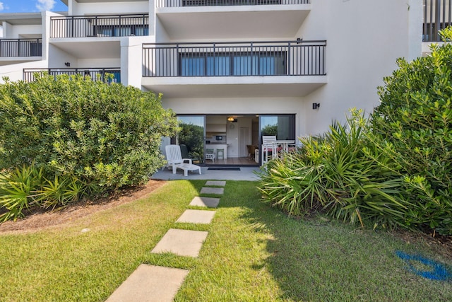 3722 E Co Highway 30a 3 3, Santa Rosa Beach, FL 32459 - rear view of property with stucco siding and a lawn