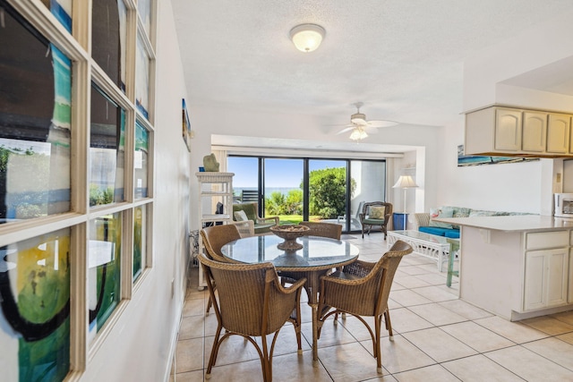 3722 E Co Highway 30a 3 3, Santa Rosa Beach, FL 32459 - dining area with light tile patterned flooring, a ceiling fan, and a textured ceiling