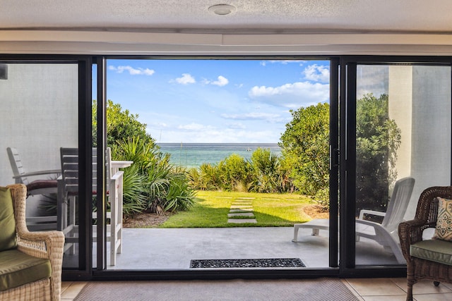 3722 E Co Highway 30a 3 3, Santa Rosa Beach, FL 32459 - entryway featuring a water view, a textured ceiling, and tile patterned floors