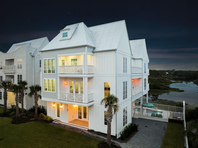 58 Woodward Dr, Santa Rosa Beach, FL 32459 - rear view of house with a balcony, board and batten siding, and a metal roof