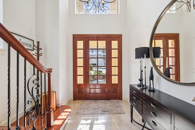 69 Cobalt Ln, Miramar Beach, FL 32550 - foyer featuring a towering ceiling, plenty of natural light, a chandelier, and stairway