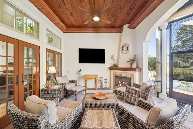 69 Cobalt Ln, Miramar Beach, FL 32550 - living room with wood ceiling, french doors, healthy amount of natural light, a ceiling fan, and a fireplace