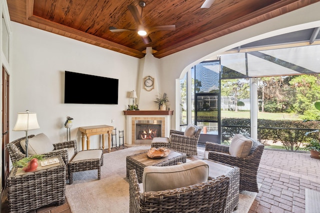 69 Cobalt Ln, Miramar Beach, FL 32550 - living area featuring wood ceiling, ceiling fan, a fireplace, brick floors, and a sunroom