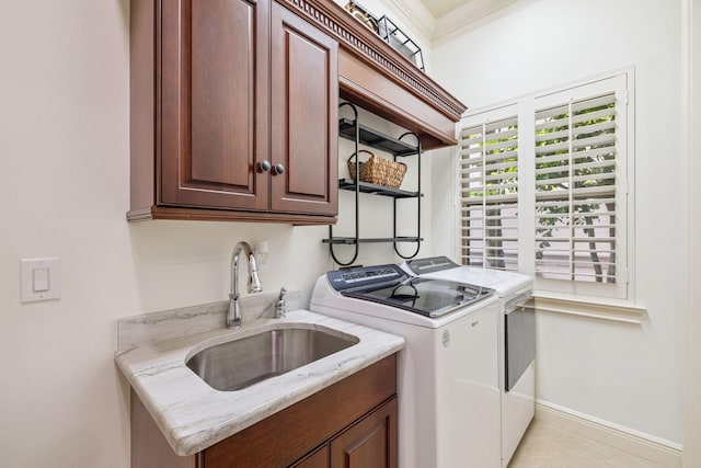 69 Cobalt Ln, Miramar Beach, FL 32550 - washroom featuring washing machine and clothes dryer, cabinet space, and crown molding