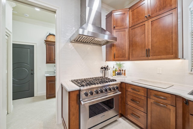 69 Cobalt Ln, Miramar Beach, FL 32550 - kitchen with wall chimney range hood, high end stainless steel range oven, decorative backsplash, ornamental molding, and brown cabinets