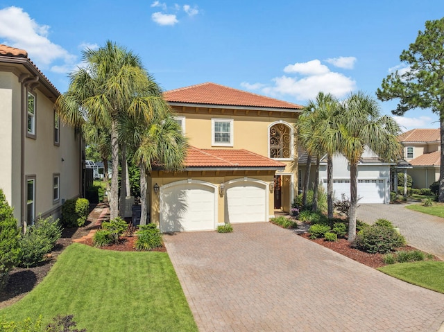 69 Cobalt Ln, Miramar Beach, FL 32550 - mediterranean / spanish home featuring stucco siding, a tiled roof, decorative driveway, and a garage