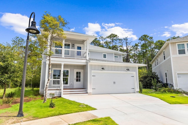 70 Oakley Ct, Santa Rosa Beach, FL 32459 - view of front facade featuring a balcony, board and batten siding, a porch, an attached garage, and concrete driveway