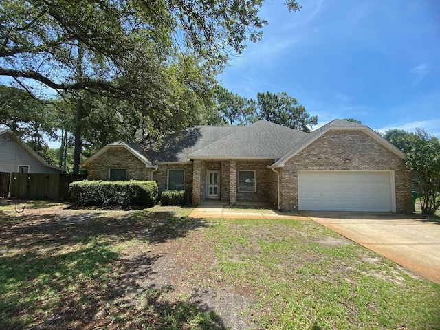 64 Hampton Cir, Niceville, FL 32578 - view of front of home with a garage, driveway, brick siding, and roof with shingles