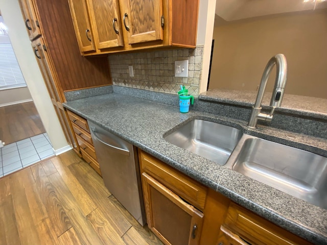 64 Hampton Cir, Niceville, FL 32578 - kitchen featuring stainless steel dishwasher, wood finished floors, brown cabinetry, and tasteful backsplash