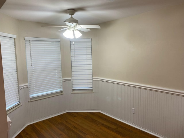64 Hampton Cir, Niceville, FL 32578 - unfurnished room with wood finished floors, wainscoting, and a ceiling fan