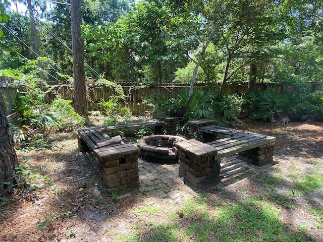 64 Hampton Cir, Niceville, FL 32578 - fenced backyard with a fire pit and a patio