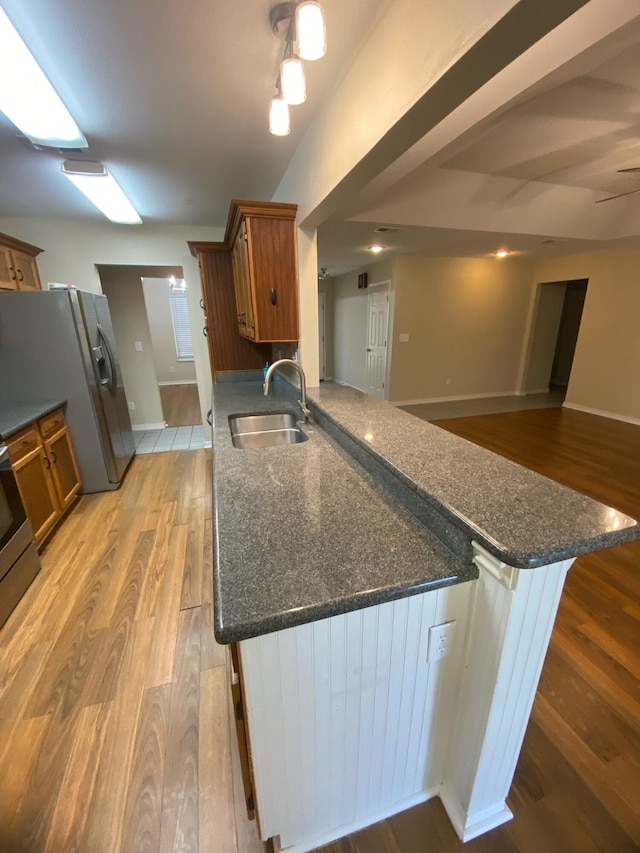 64 Hampton Cir, Niceville, FL 32578 - kitchen with brown cabinets, light wood-type flooring, and stainless steel refrigerator with ice dispenser