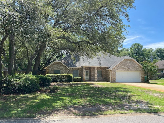 64 Hampton Cir, Niceville, FL 32578 - view of front of house with an attached garage, a front lawn, driveway, and brick siding