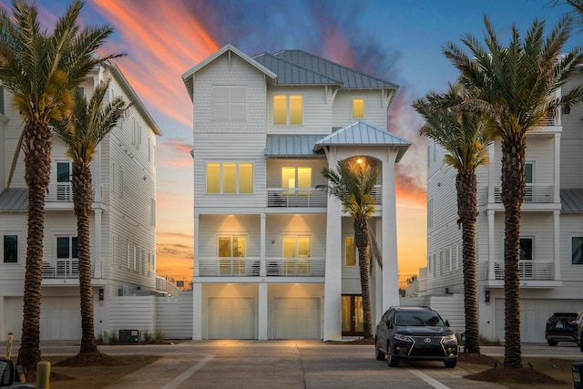 17 Palm Court Ln, Inlet Beach, FL 32461 - view of front facade with a standing seam roof, a garage, a metal roof, and driveway