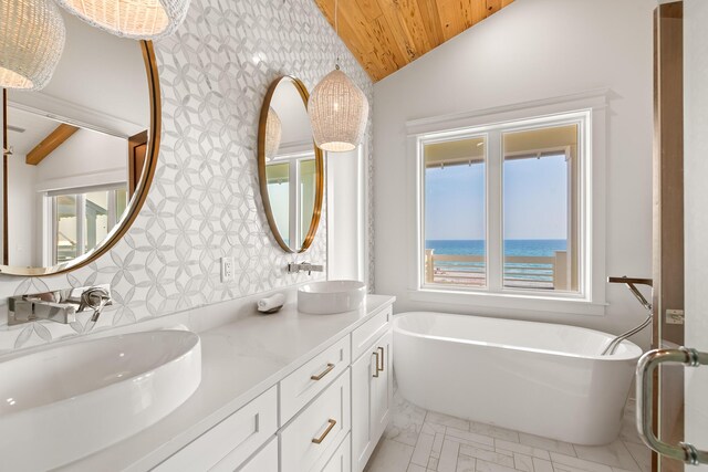 17 Palm Court Ln, Inlet Beach, FL 32461 - full bathroom featuring vaulted ceiling, wood ceiling, a freestanding bath, double vanity, and wallpapered walls