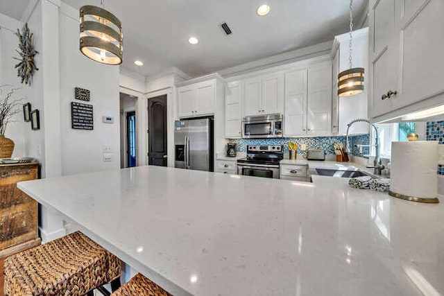 23 The Greenway Loop, Inlet Beach, FL 32461 - kitchen featuring appliances with stainless steel finishes, tasteful backsplash, a peninsula, light stone counters, and recessed lighting