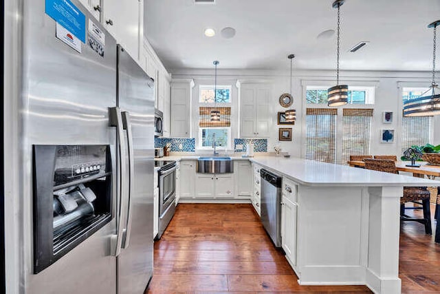 23 The Greenway Loop, Inlet Beach, FL 32461 - kitchen featuring stainless steel appliances, a peninsula, healthy amount of natural light, and light countertops