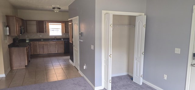 2496 S Lakeview Dr, Crestview, FL 32536 - kitchen featuring dark countertops, black microwave, decorative backsplash, and dark carpet