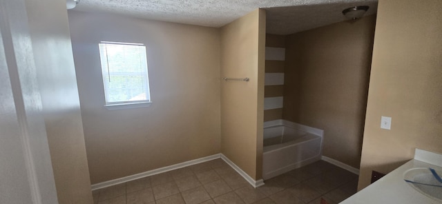 2496 S Lakeview Dr, Crestview, FL 32536 - full bathroom featuring a tub, tile patterned floors, a textured ceiling, and vanity