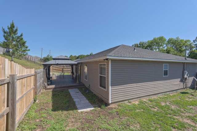 405 Bobby Dr, Crestview, FL 32536 - view of side of home featuring a gazebo, a fenced backyard, a wooden deck, and a shingled roof