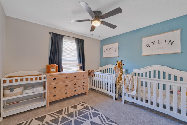 405 Bobby Dr, Crestview, FL 32536 - carpeted bedroom with a nursery area, a ceiling fan, and a textured ceiling