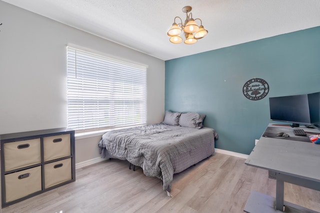 405 Bobby Dr, Crestview, FL 32536 - bedroom featuring a chandelier and light wood-type flooring