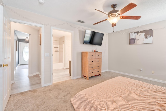 405 Bobby Dr, Crestview, FL 32536 - bedroom featuring light carpet, ensuite bathroom, and ceiling fan