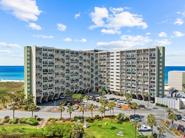23223 Front Beach Rd # 112, Panama City Beach, FL 32413 - view of apartment building / complex featuring uncovered parking and a water view