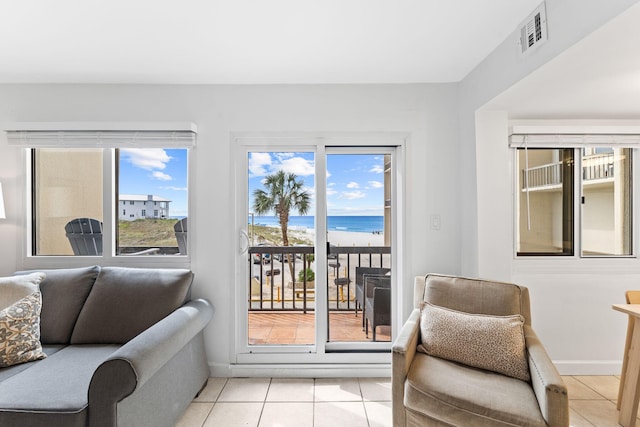 23223 Front Beach Rd # 112, Panama City Beach, FL 32413 - living room featuring light tile patterned floors and a water view