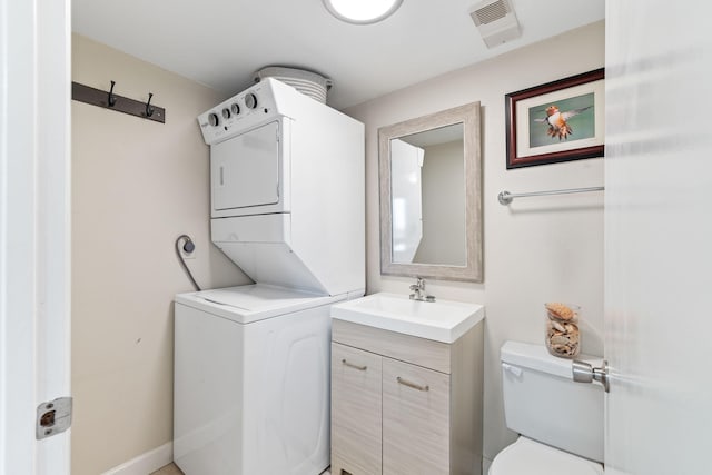 23223 Front Beach Rd # 112, Panama City Beach, FL 32413 - washroom featuring stacked washer / dryer