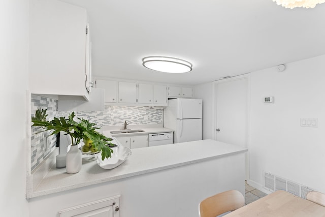 23223 Front Beach Rd # 112, Panama City Beach, FL 32413 - kitchen featuring white appliances, light countertops, a peninsula, and decorative backsplash