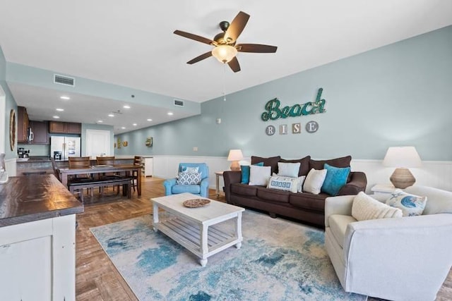 16701 Front Beach Rd Unit 1807, Panama City Beach, FL 32413 - living room featuring a wainscoted wall, ceiling fan, and wood finished floors