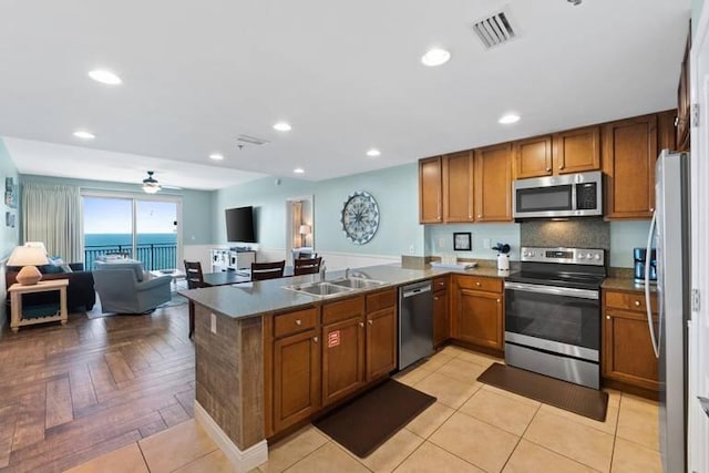 16701 Front Beach Rd Unit 1807, Panama City Beach, FL 32413 - kitchen with stainless steel appliances, brown cabinetry, a peninsula, open floor plan, and recessed lighting