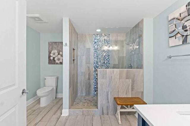 16701 Front Beach Rd Unit 1807, Panama City Beach, FL 32413 - bathroom featuring a walk in shower, vanity, and wood finished floors