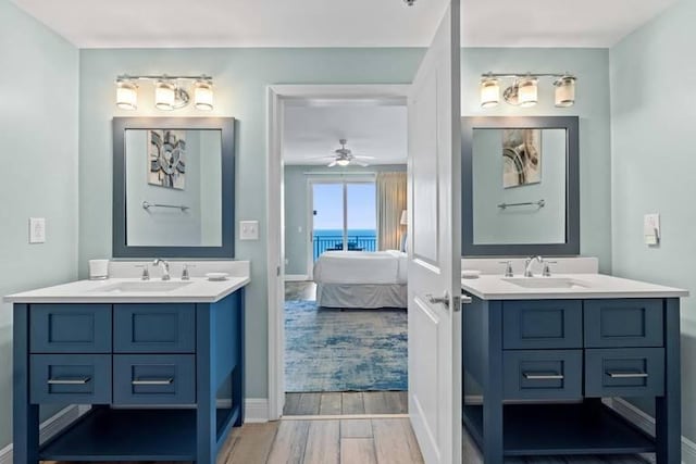 16701 Front Beach Rd Unit 1807, Panama City Beach, FL 32413 - bathroom featuring ensuite bathroom, two vanities, wood finished floors, and ceiling fan