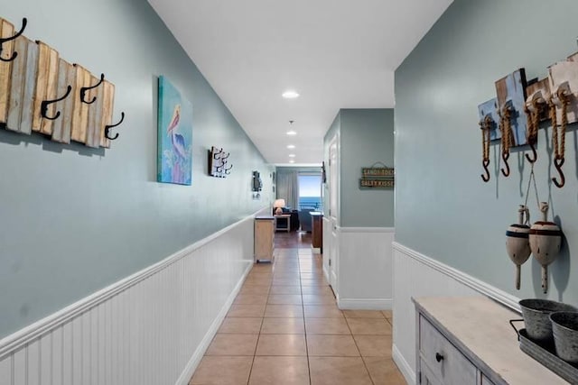 16701 Front Beach Rd Unit 1807, Panama City Beach, FL 32413 - corridor featuring a wainscoted wall, light tile patterned flooring, and recessed lighting