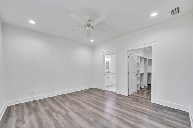 2672 Chat Holley Rd, Santa Rosa Beach, FL 32459 - unfurnished bedroom with crown molding, wood finished floors, a walk in closet, ensuite bathroom, and recessed lighting