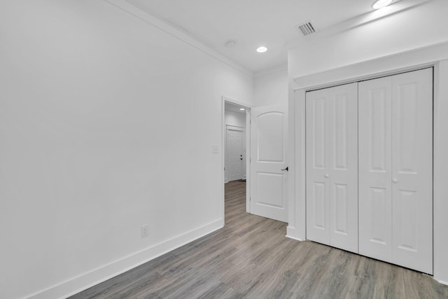 2672 Chat Holley Rd, Santa Rosa Beach, FL 32459 - unfurnished bedroom with wood finished floors, a closet, recessed lighting, and crown molding